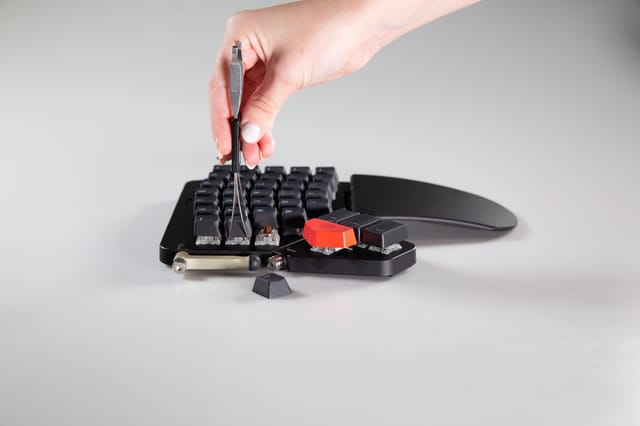 keycaps being removed by the appropriate tool